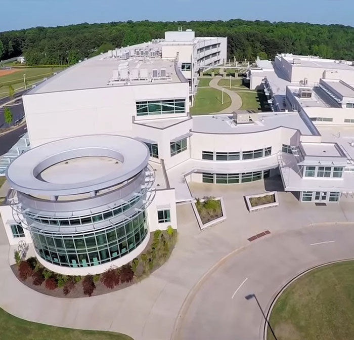 Aerial view of Dr. Phinnize J Fisher Middle School in Greenville County, South Carolina surrounded by greenery and winding pathways.