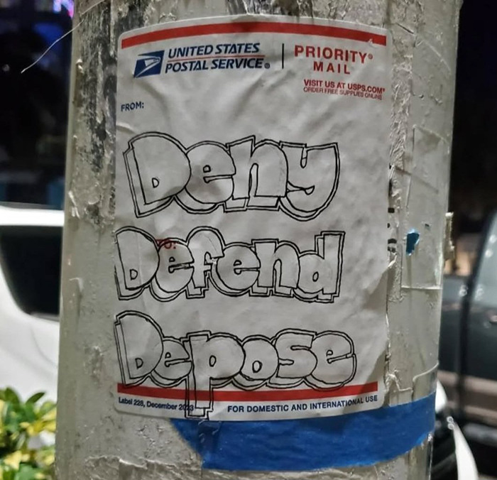 USPS sticker with "Deny Defend Depose" graffiti.