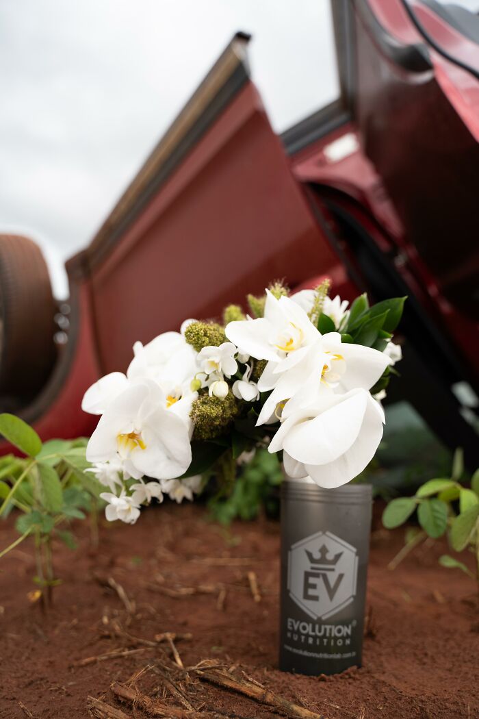 Overturned car scene with flowers in foreground, capturing the accident moment for a unique photo shoot.