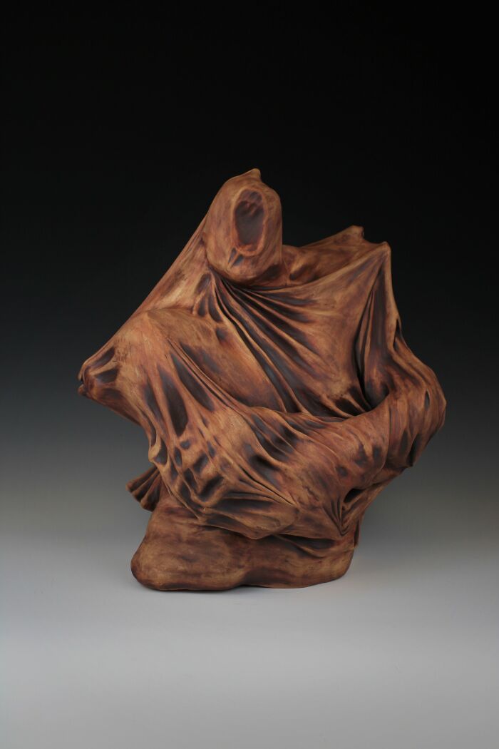 Surreal ceramic art sculpture by Jackson Shaner, depicting an abstract form with flowing, textured surfaces.