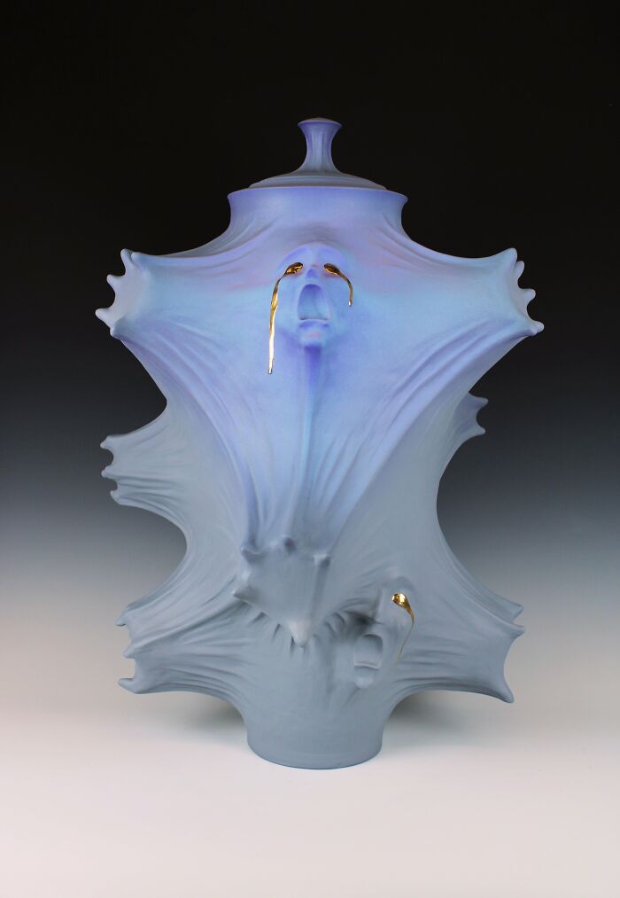 Surreal ceramic art piece by Jackson Shaner, featuring a unique blue sculptural design with gold accents.