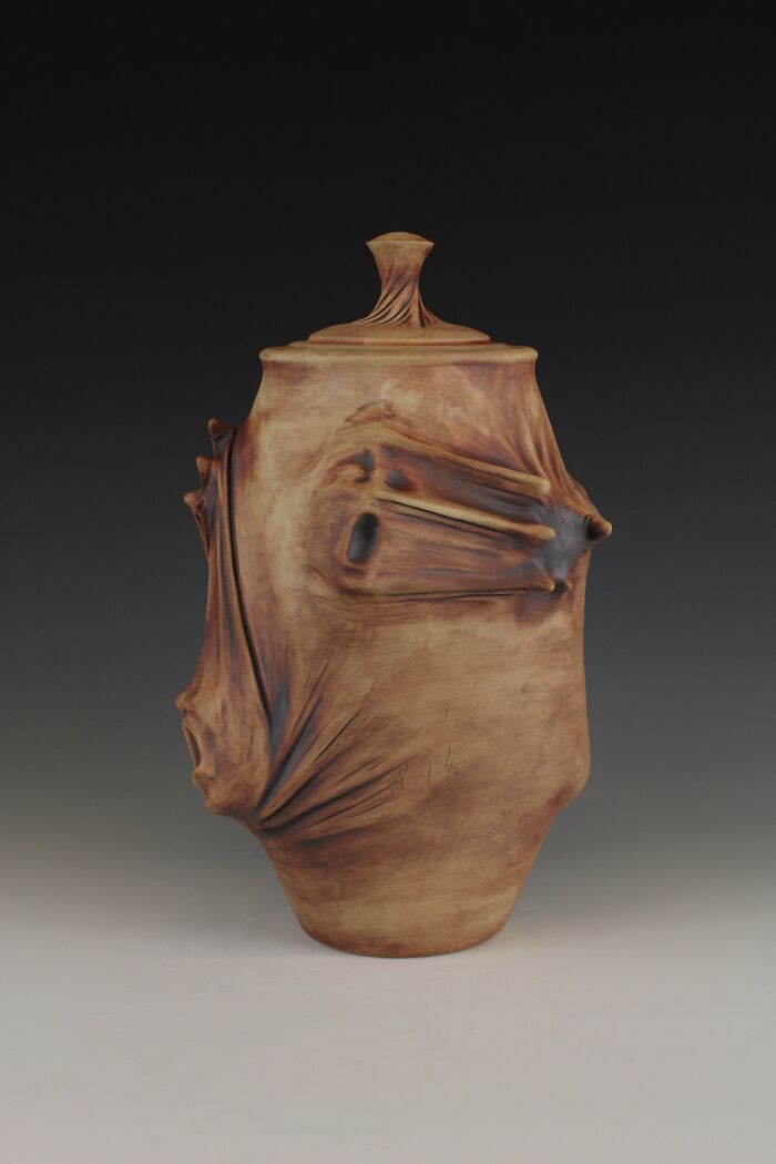 Surreal ceramic art with abstract shapes and earthy tones, evoking emotion and creativity by artist Jackson Shaner.