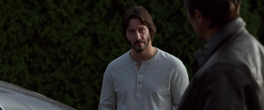 Actor Keanu Reeves in a casual henley shirt outdoors, exemplifying actors known for consistently playing themselves in films.