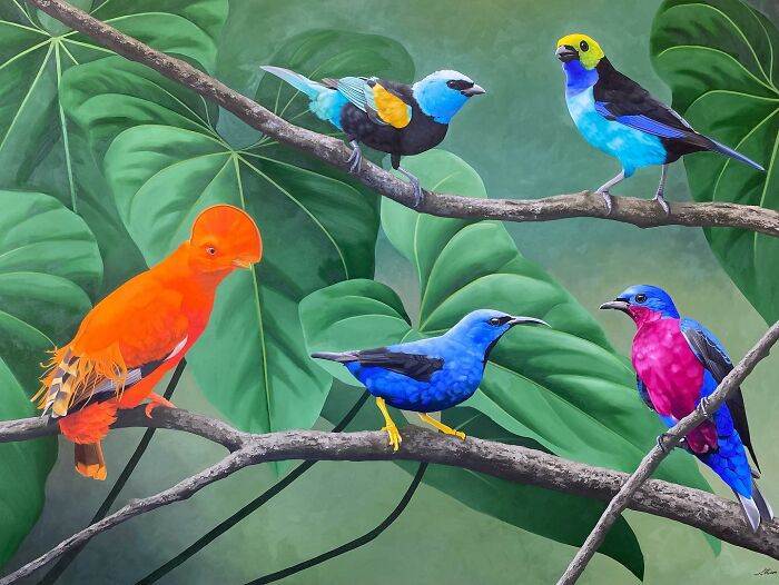 Colorful birds on branches, showcasing Brazilian artist's feather art against lush green leaves.