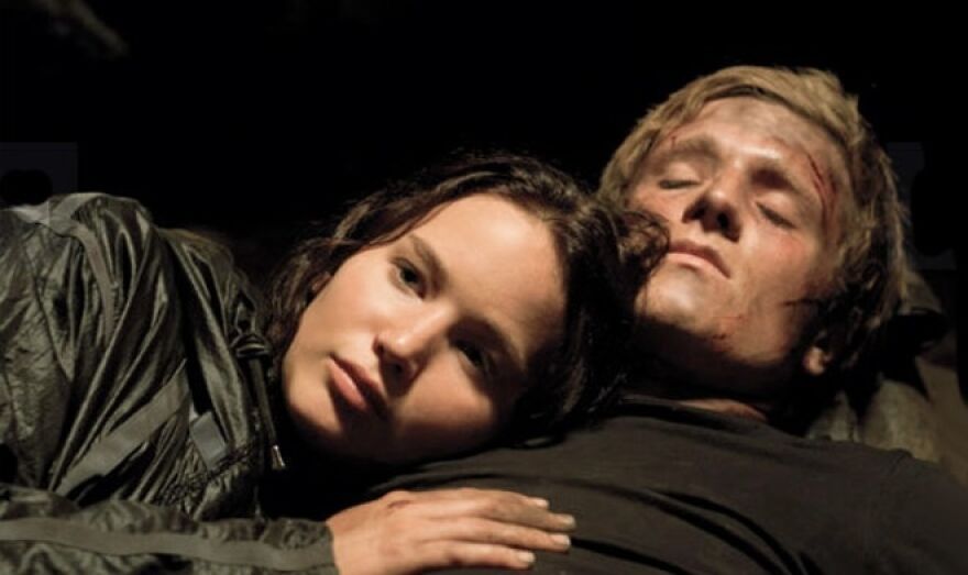 Couple from a movie resting together in The Hunger Games.