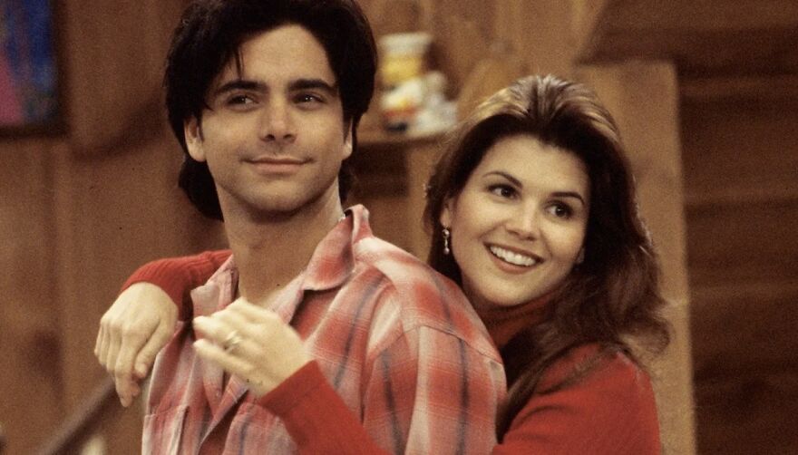 Couple embracing in cozy setting, representing a movie couple relationship in Full House series.