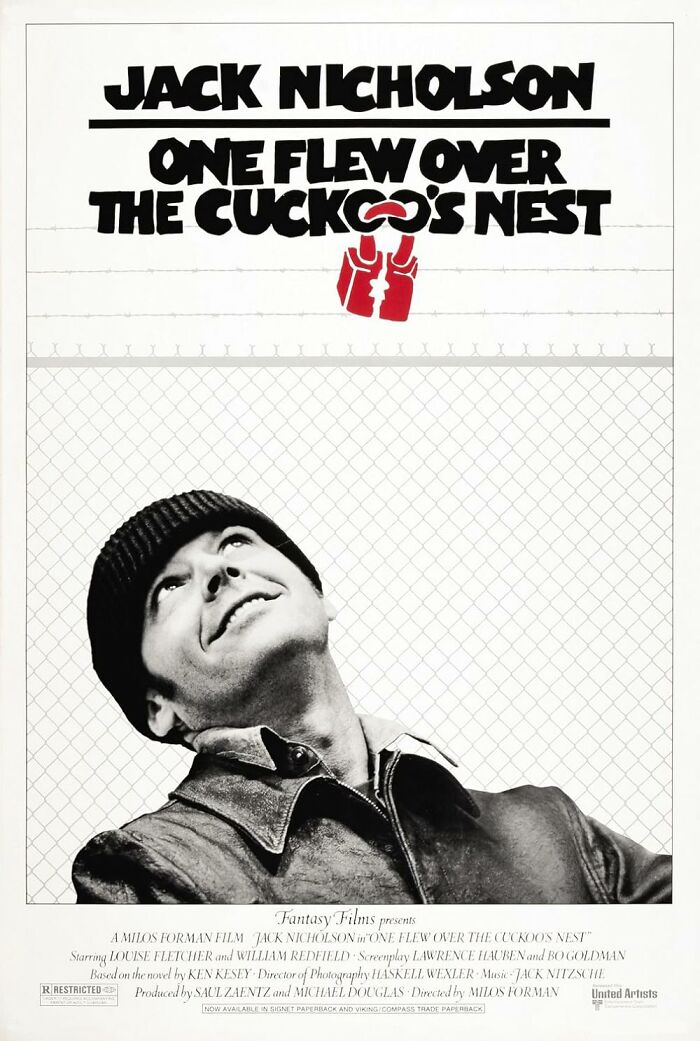 "One Flew Over the Cuckoo's Nest movie poster with smiling man in front of fence."