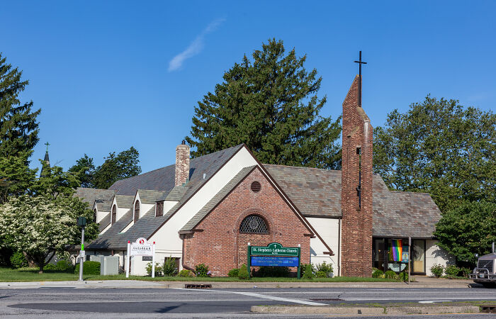 Historic church building with a cross and red brick facade, reflecting significant moments influencing history.