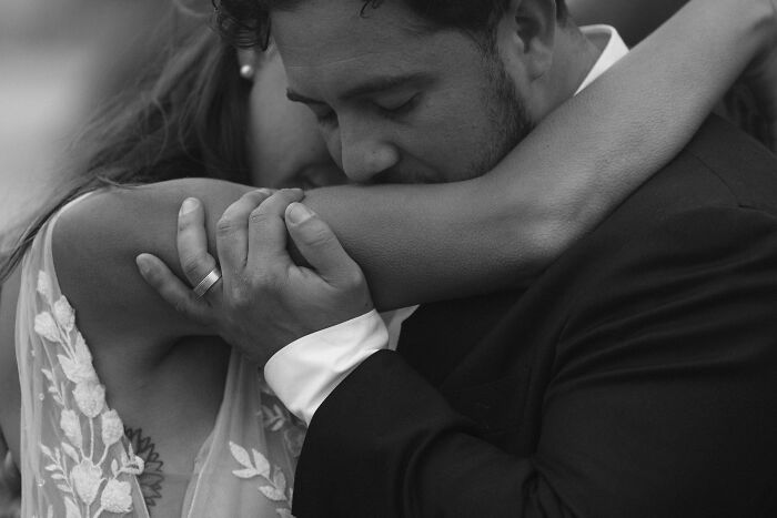 Tender embrace between bride and groom, highlighting top wedding photos of 2024.