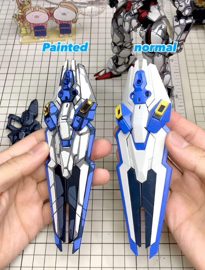 Painted vs. normal Gundam action figure parts showcased on a grid surface for comparison.