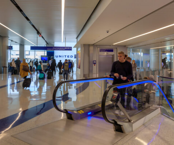 United Airlines terminal with passengers walking by.