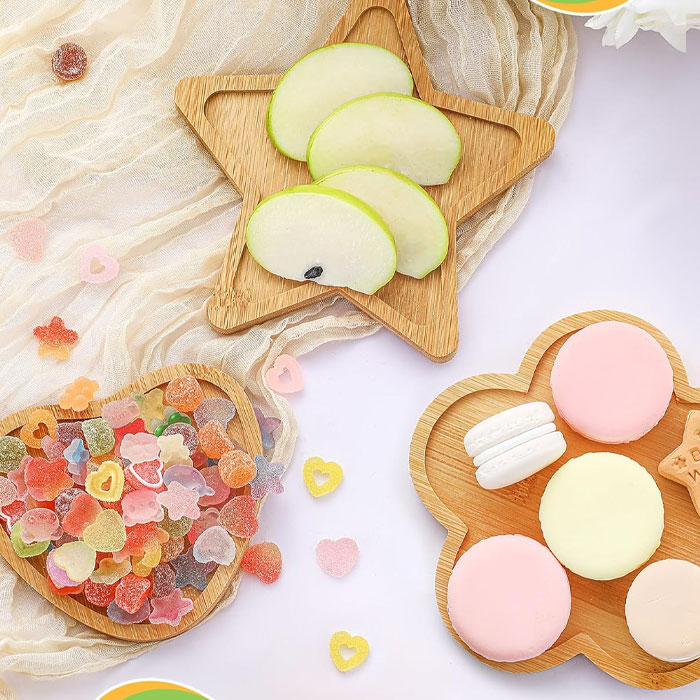 Assorted sweets and apple slices on star-shaped trays, showcasing creative ways to gift a gift card.