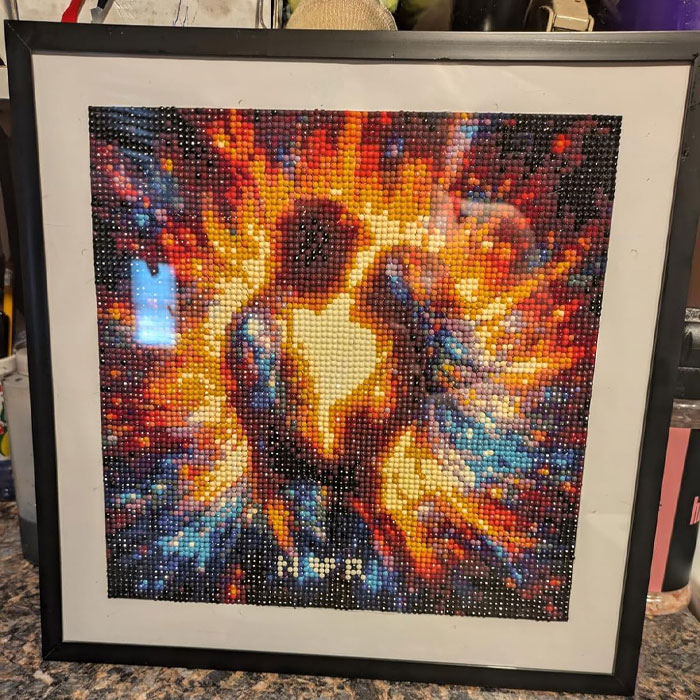 Framed pixel art of a couple surrounded by vibrant colors, illustrating creative gift card presentation.