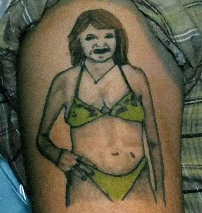 A humorous tattoo fail depicting a woman in a bikini with exaggerated features on a person's arm.