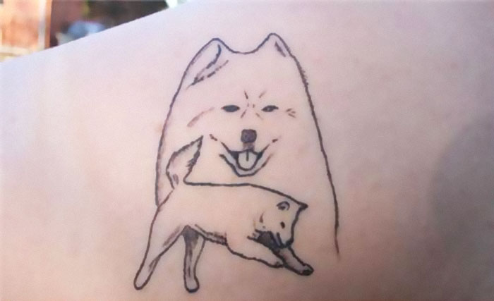 Funny worst tattoo fail depicting poorly drawn dogs on skin.