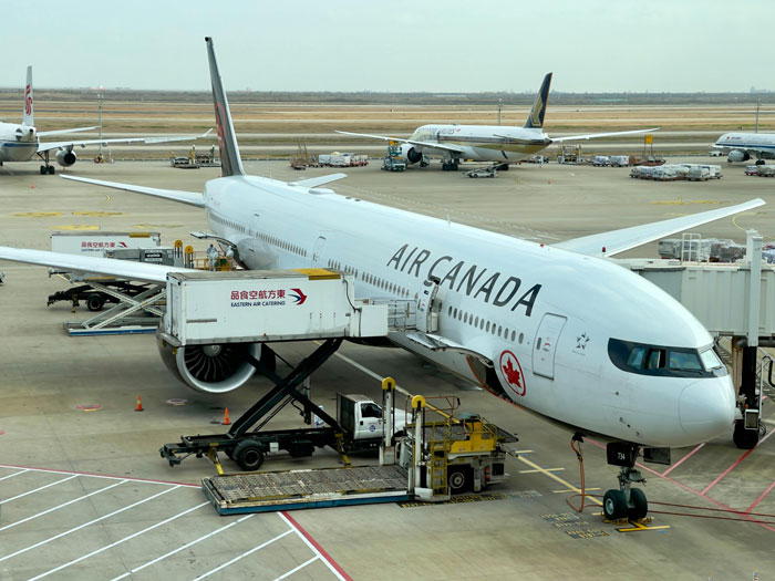 Air Canada plane at airport gate, highlighting travel and mobility issues.