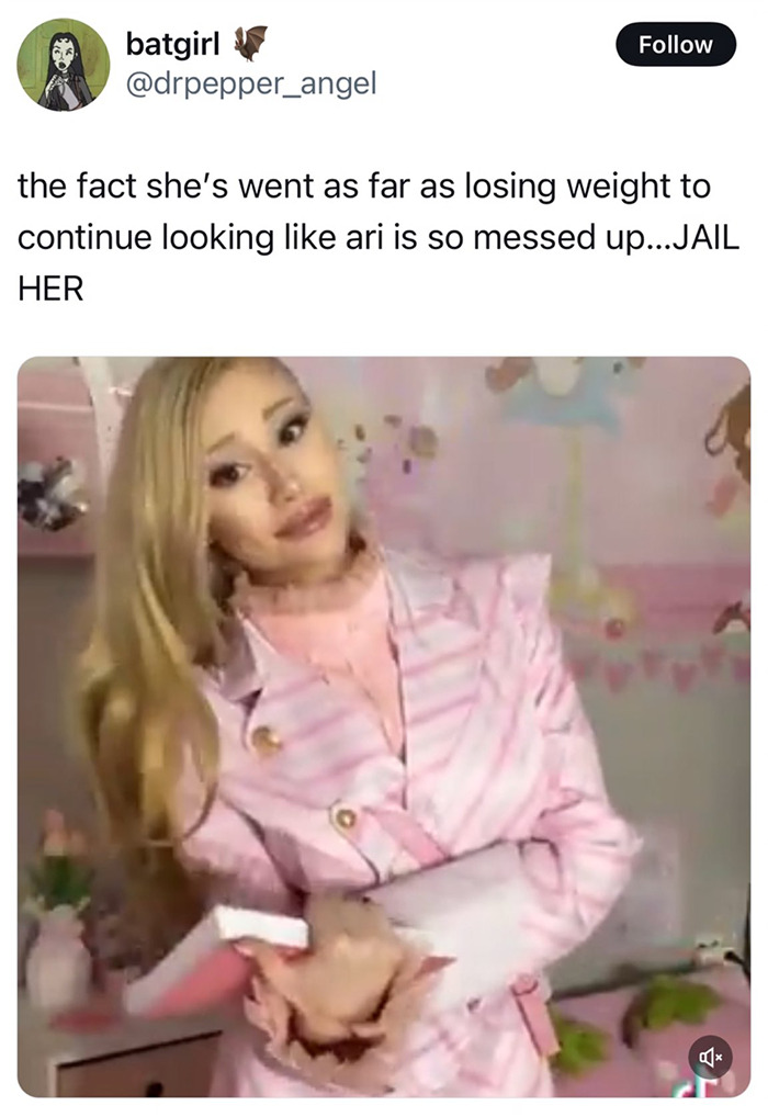 Ariana Grande impersonator posing in pink outfit, facing criticism for weight loss to resemble her.