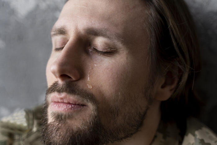 Man in deep thought, tear on cheek, reflecting on bad-good habit.