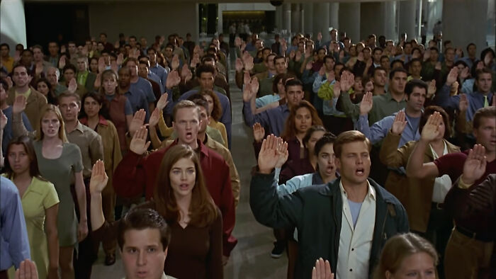 A large group of people raising hands, exemplifying a story where the 'bad guys' are actually right.