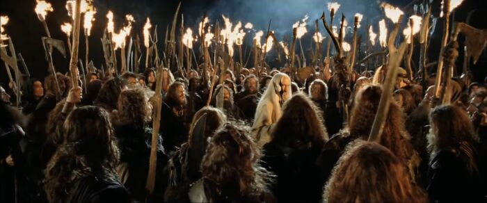 The Dunlendings in "Lord of the Rings" holding torches in a night scene, depicting a story with 'bad guys' who are completely right.