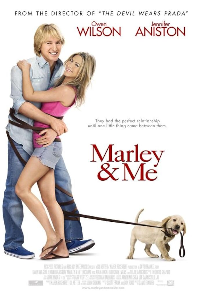 "Movie poster of a couple hugging with a playful puppy on a leash for the film 'Marley & Me'."