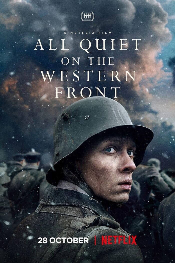 "Soldier looking back amid chaos in the movie 'All Quiet on the Western Front' poster, highlighting impactful war cinematography."