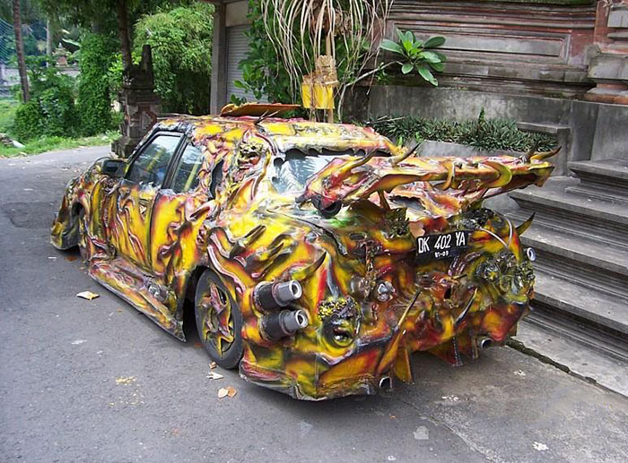 Car-Fails: Overdecorated vehicle with bright colors and unusual attachments parked on a street.