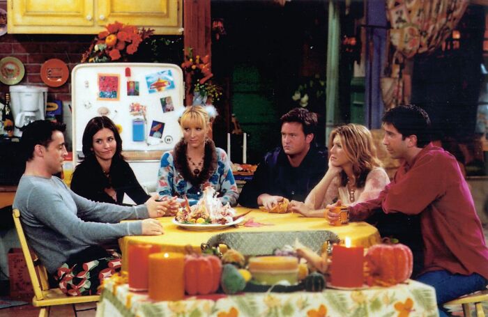 Characters from a popular TV show gather around a table, sparking fascinating fan theories.