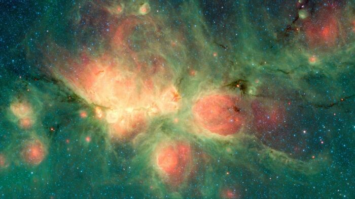 Colorful nebula in space, showcasing vibrant clouds and star formations.