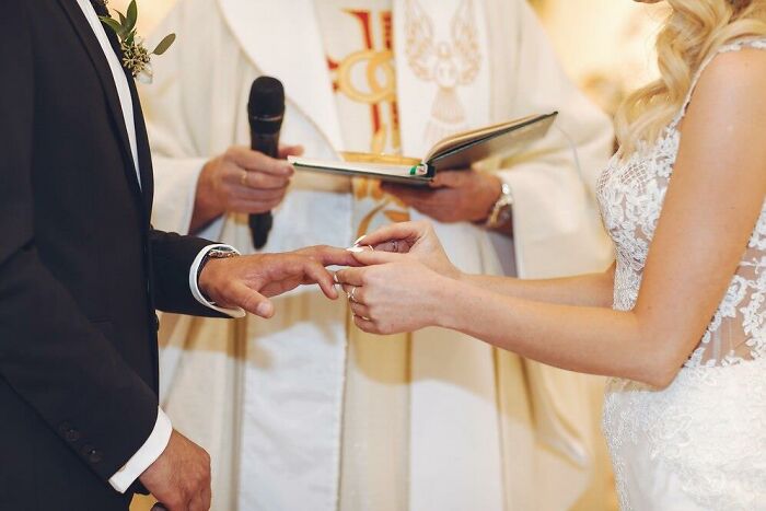 Bride and groom exchanging rings during wedding ceremony, symbolizing potential for worst things to happen unexpectedly.