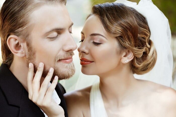 Bride and groom embracing closely, highlighting a serene wedding moment.