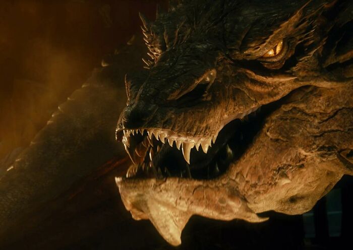 Dragon in a fierce pose, showcasing its sharp fangs and intense expression in a dark, atmospheric setting.