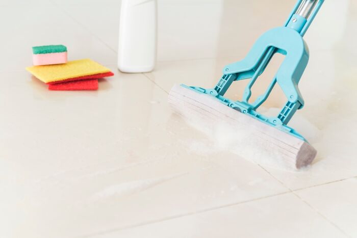 Floor mop and cleaning supplies for frugal home hacks, showcasing affordable ways to maintain a clean household.