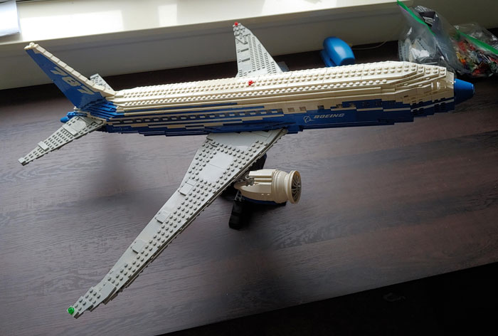 LEGO airplane build on a wooden table, showcasing an impressive example of cool LEGO builds.