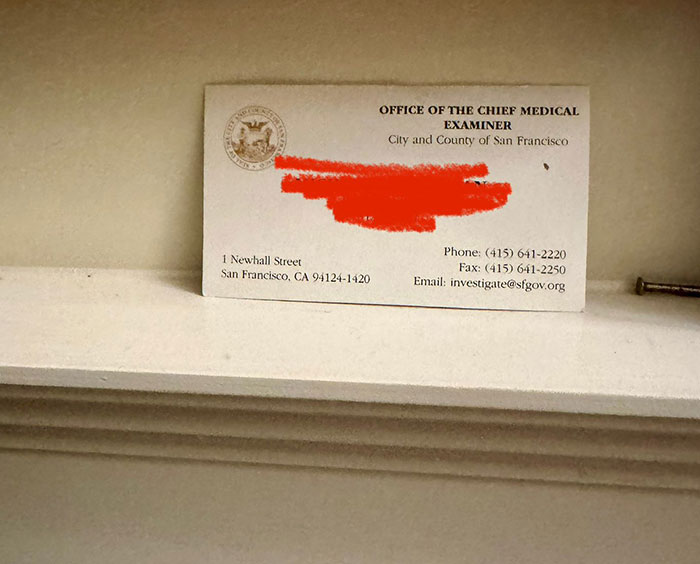 Business card for the Office of the Chief Medical Examiner in San Francisco, placed on a white surface.