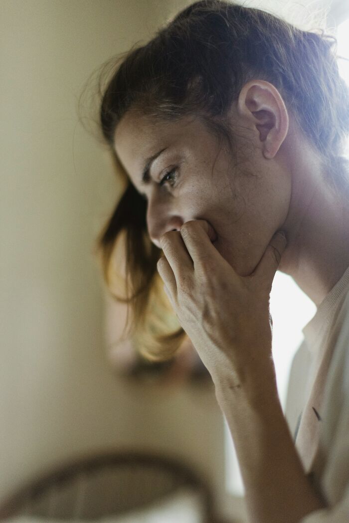 A pensive woman looks thoughtful, illustrating a story of someone surviving against all odds.