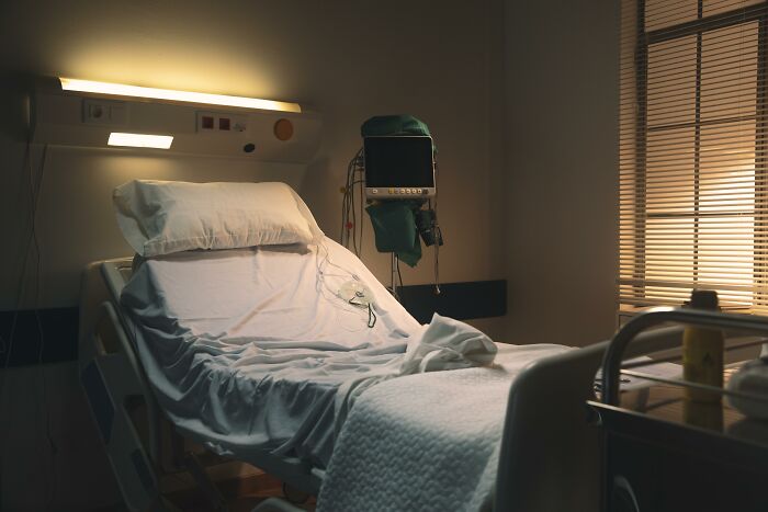 Empty hospital bed under soft lighting, symbolizing an astonishing coincidence scenario.