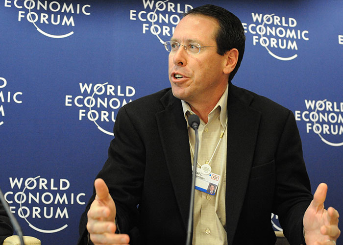 Business executive speaking at the World Economic Forum, illustrating CEO management challenges.