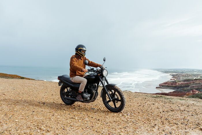 Person on a motorcycle by the seaside, emphasizing the difference exercise can make.