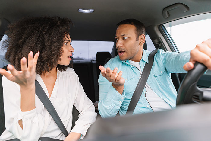 Couple arguing in a car, highlighting issues with selling a vehicle due to a fiancé's demand.