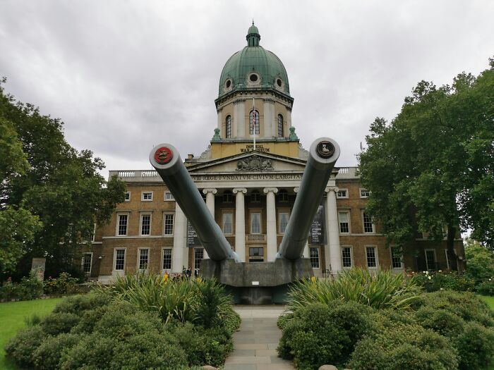 Historic building with large artillery guns, surrounded by greenery, illustrating an astonishing coincidence.