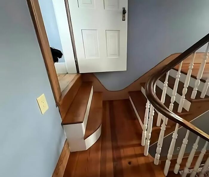 Stairs leading up to a door placed directly above them, showcasing a construction fail.