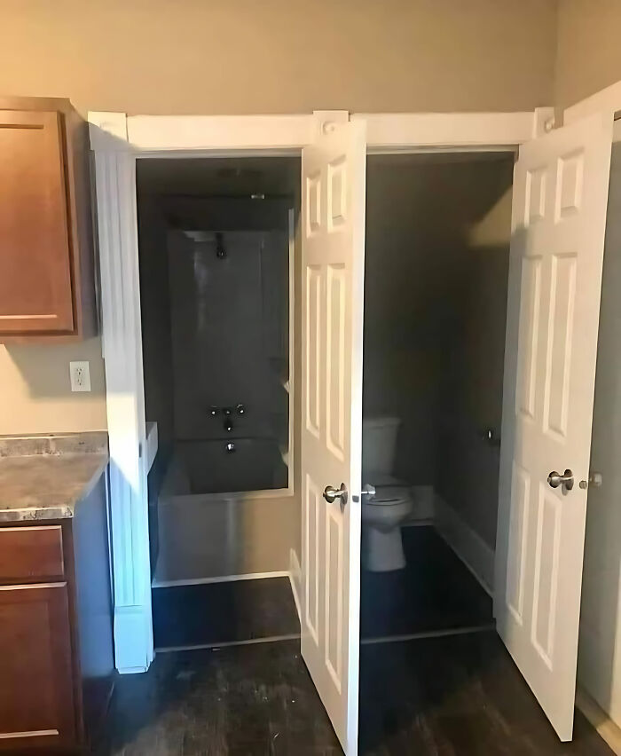 Construction fail showing overlapping bathroom doors in small space.