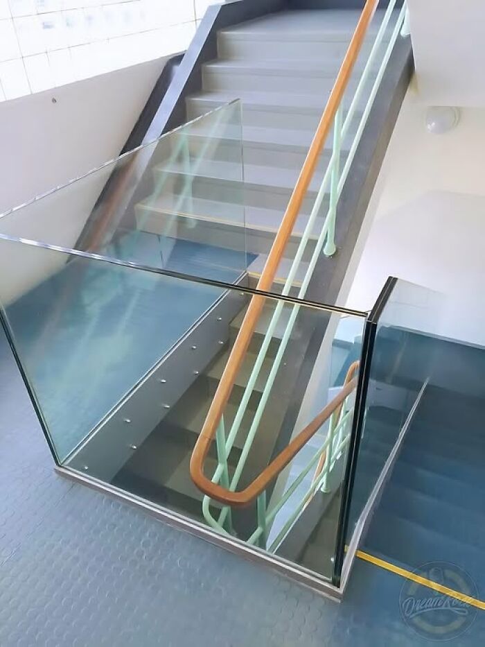 Glass barrier blocking staircase, a classic construction fail highlighting a common architectural oversight.