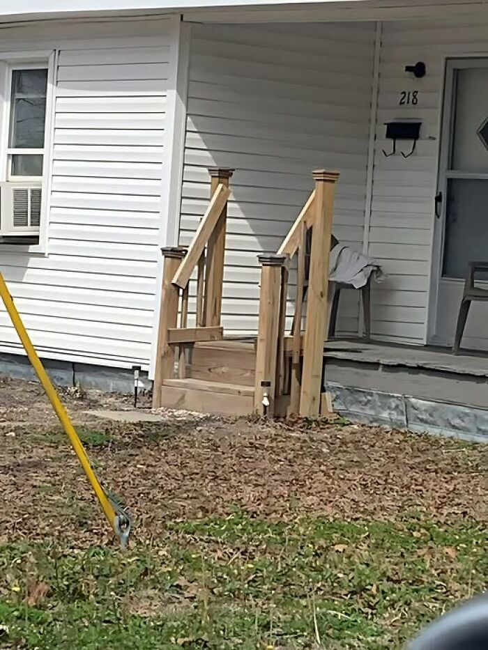 Wooden staircase leading to a closed wall, highlighting construction fails humorously.