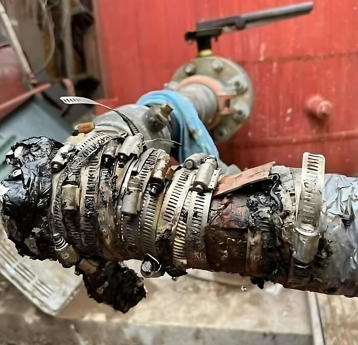 A messy series of clamps attempts to fix a leaking pipe, illustrating a hilarious construction fail.