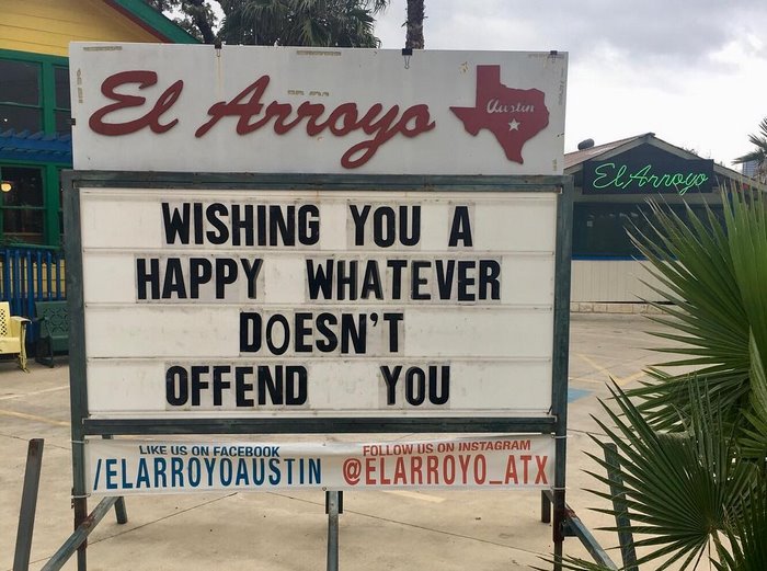 El Arroyo sign: “Wishing you a happy whatever doesn’t offend you,” with social media handles displayed below.