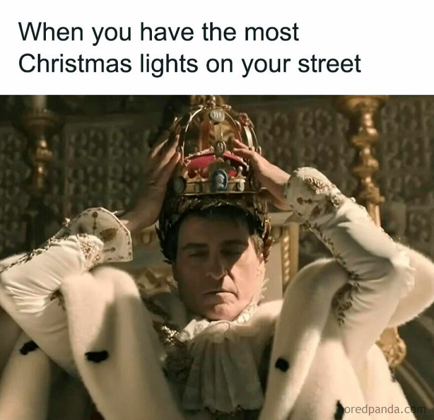 Man dressed as a king humorously adjusting a crown, representing feeling triumphant about having the most Christmas lights.