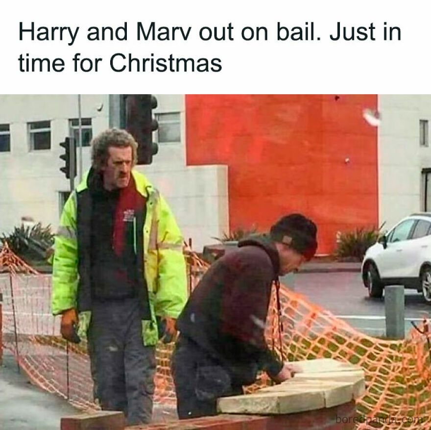 Two men resembling Harry and Marv humorously working at a construction site. Funny Christmas memes.