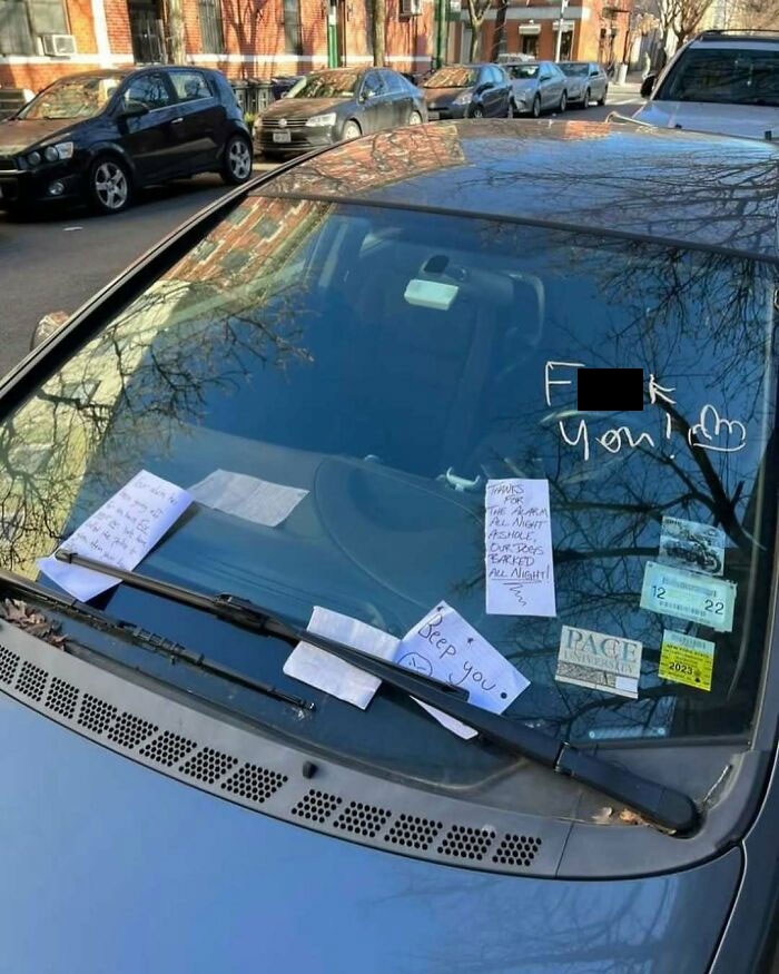 Car windshield in New York covered with humorous angry notes expressing frustration.